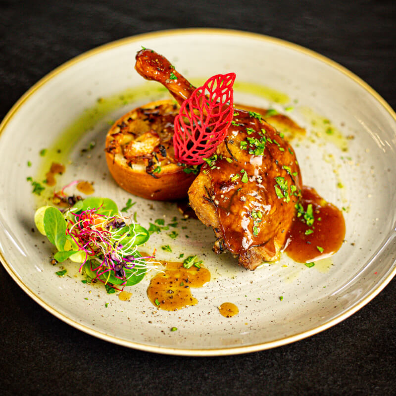 Duck leg confit with gravy sauce and fried cabbage and noodles hidden in chimney cake ring (1)